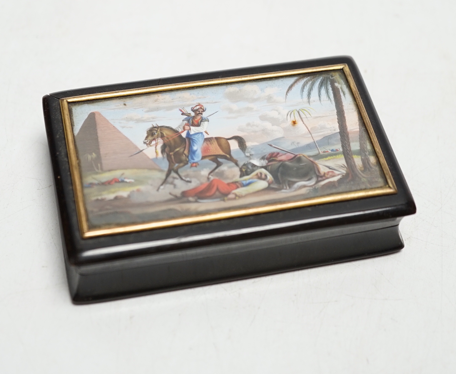 A 19th century tortoiseshell table snuff box, the hinged lid painted with an Egyptian battle scene, 9cm wide x 5.5cm deep